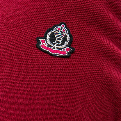 Burgundy knit and embroidered badge detail
